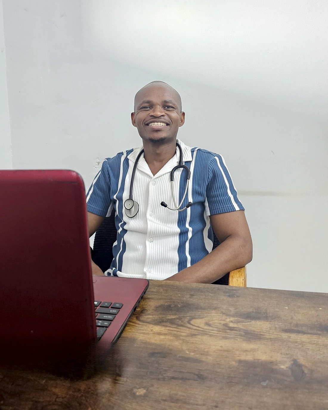Dr Sivuyile Tshayingwe at his desk